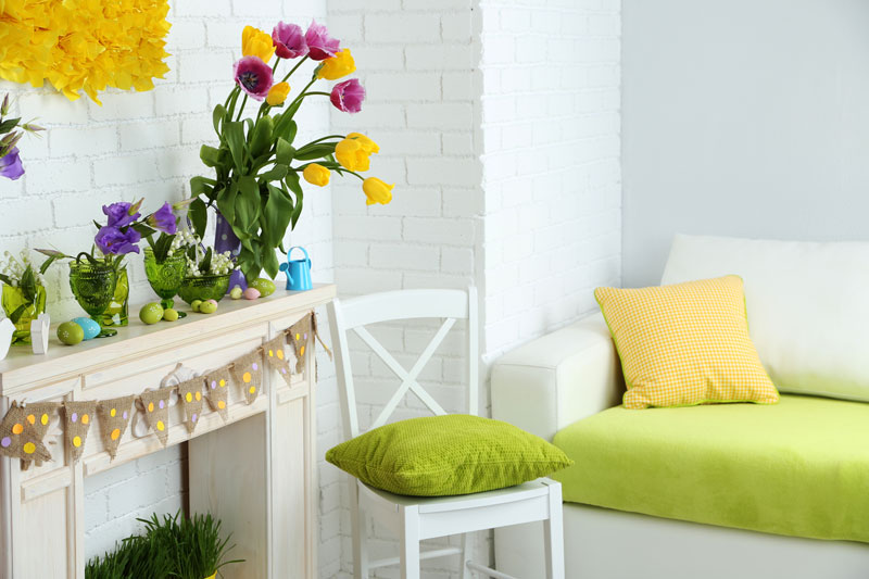 Interior Photo of Apartment/Condo with White Brick Walls, White Furniture and Decorative Flowers